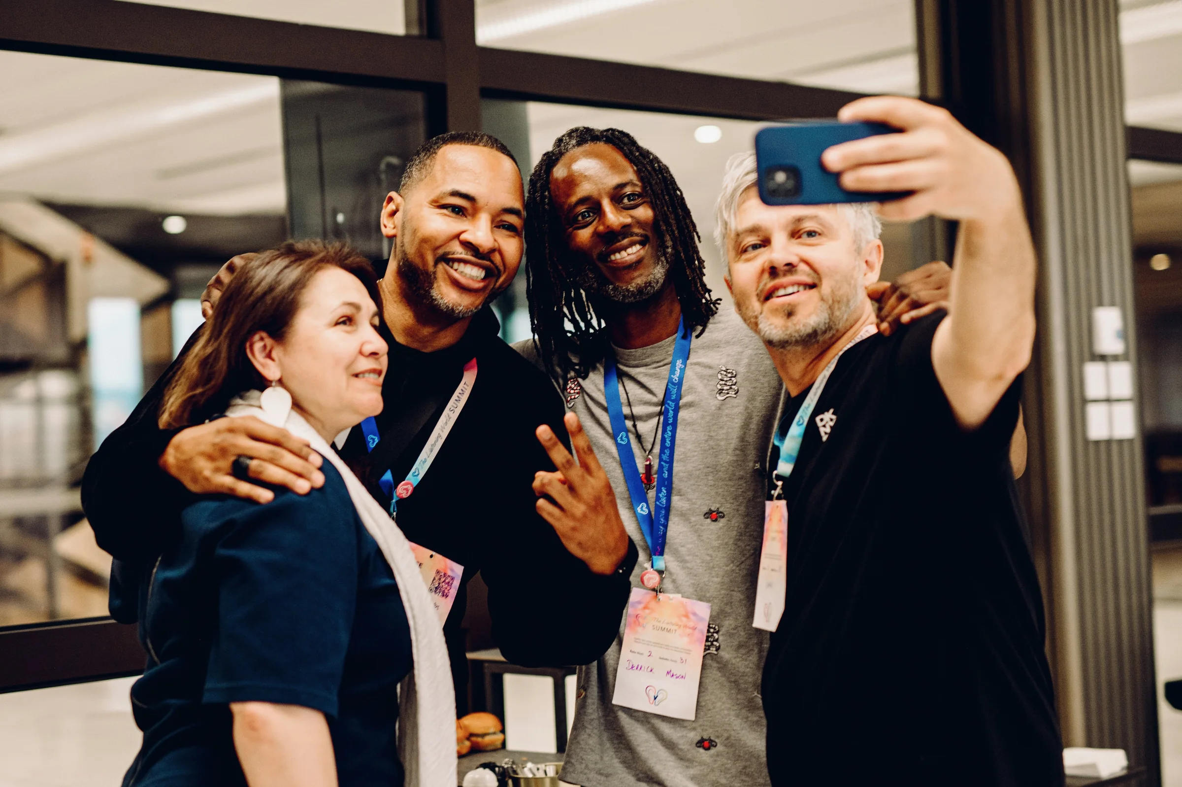 Rob Cook smiling for a group selfie with event attendees