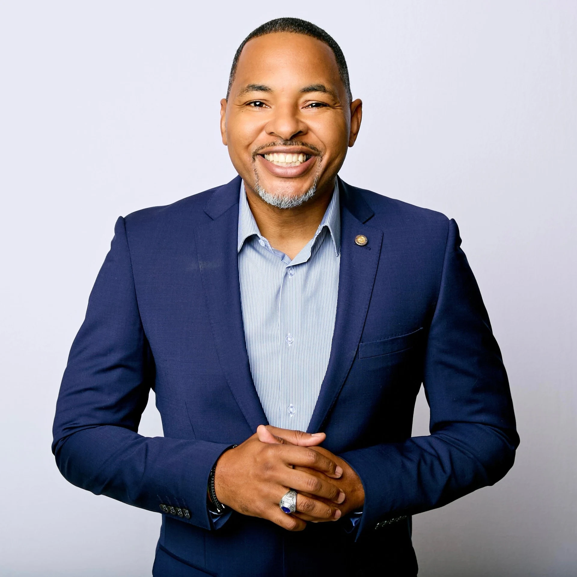 Rob Cook smiling at the camera in a navy suit